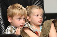 Jasper and Tessa looking intently at the TV