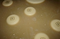 Cheeses floating in a salt water bath