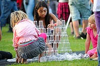 Children stacking plastic glasses