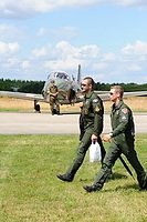 Two pilots walking away from their planes